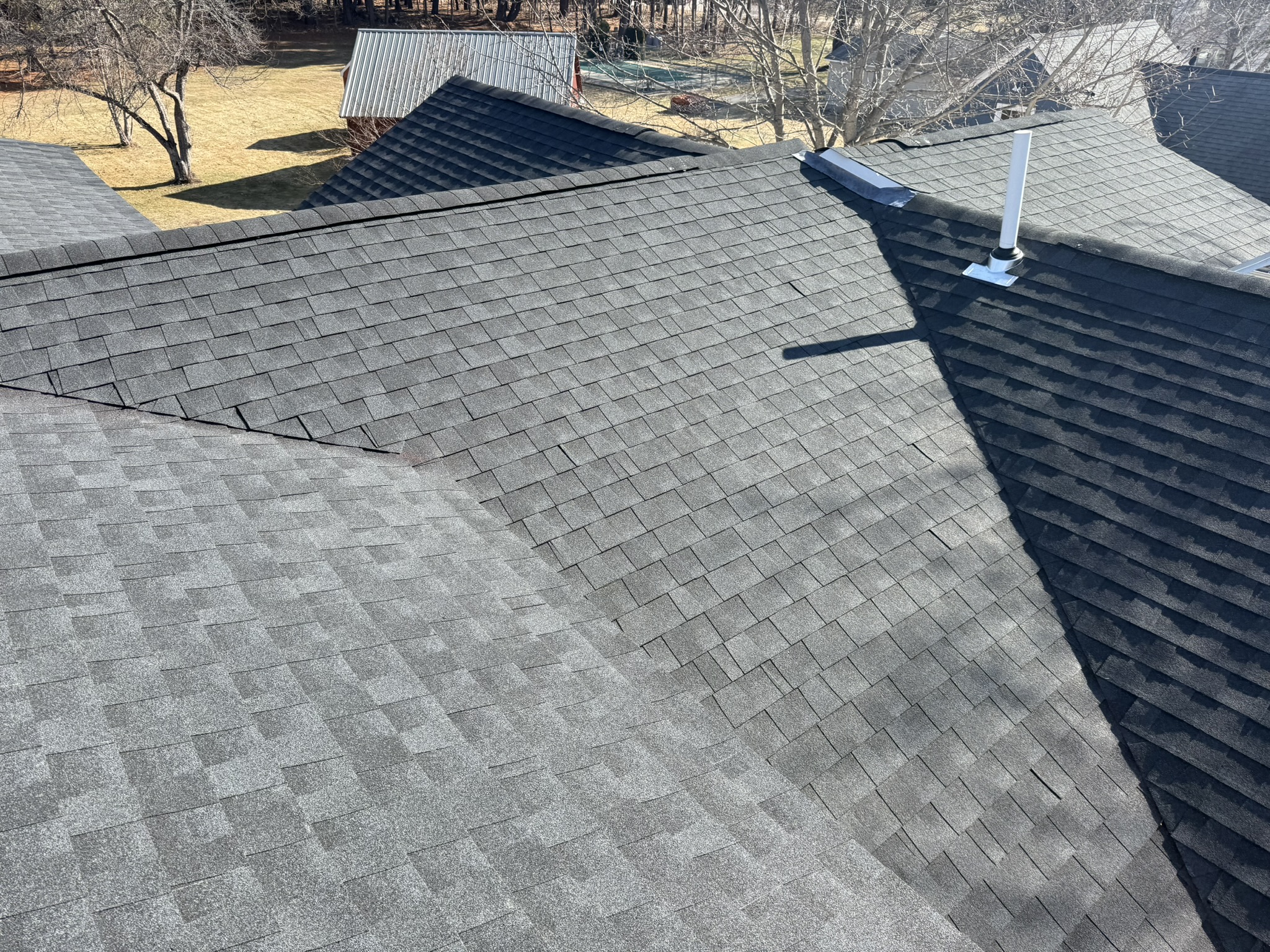 Close-up view of professional GAF Timberline HDZ shingle installation showing clean ridge line work