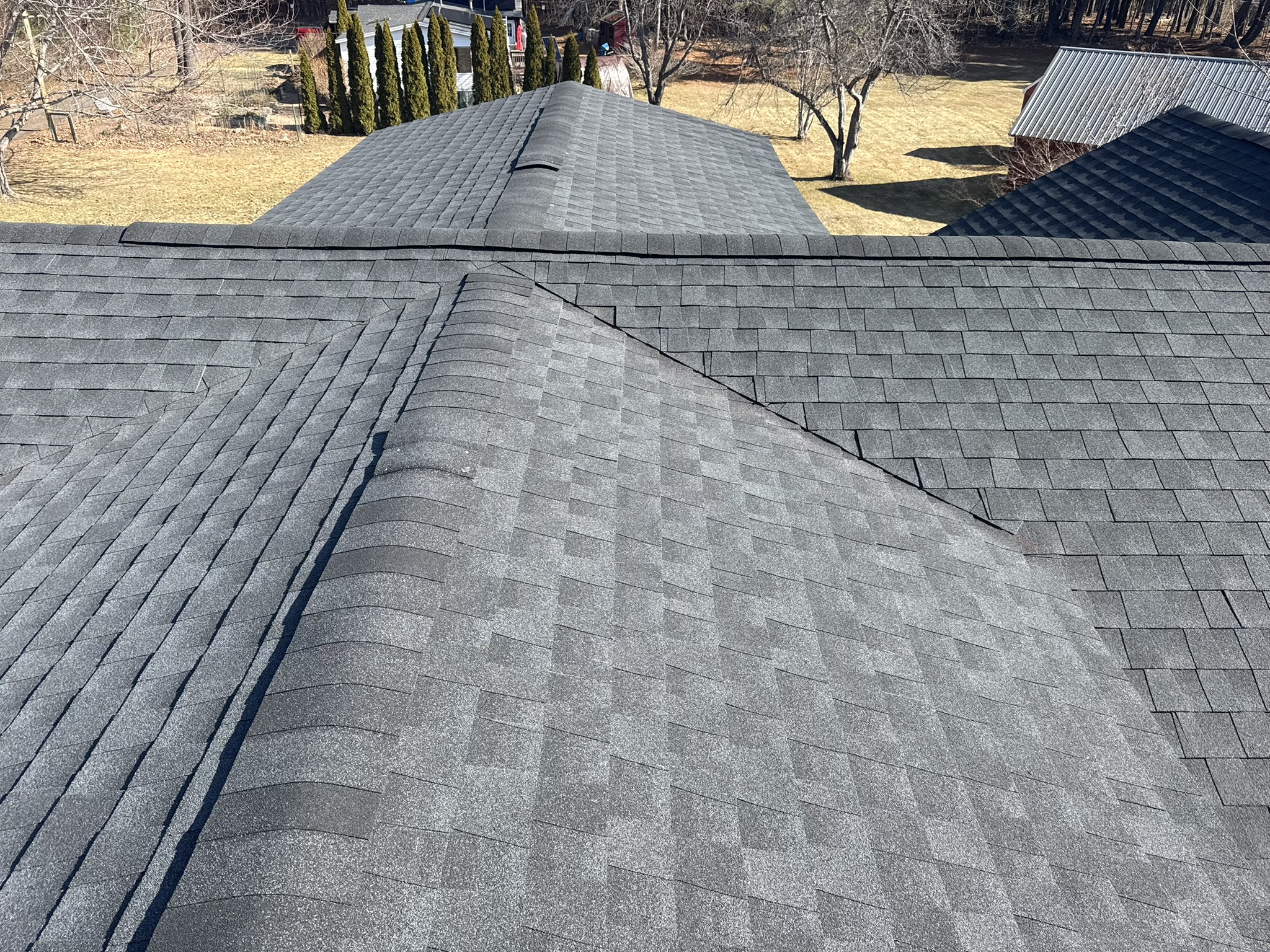 Aerial view of a newly completed roofing project featuring dimensional GAF shingles in Southern Maine