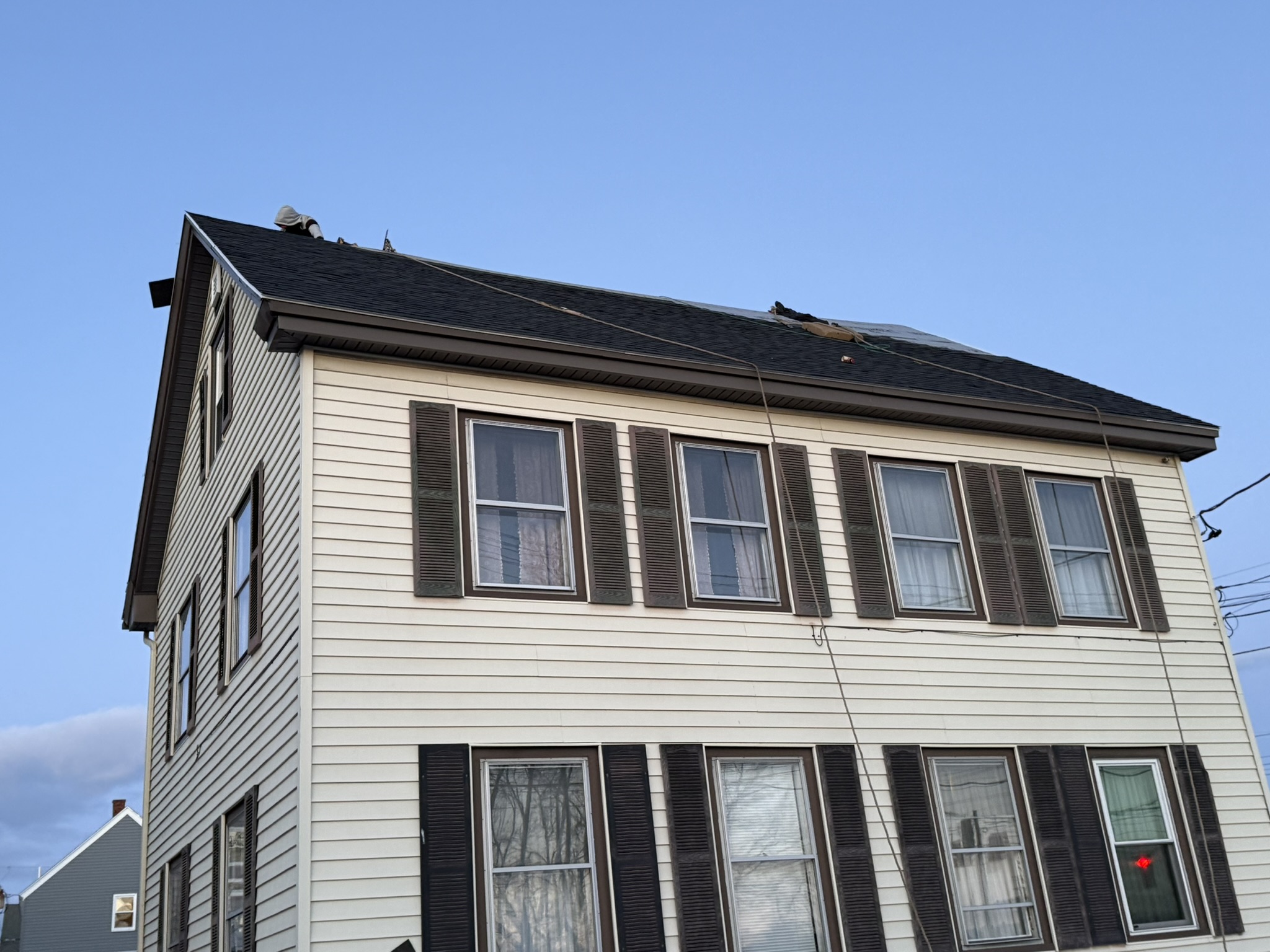 Southern Maine Roofs team installing a new roof on a local home